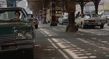 Movie still from “Prince of the City” (1981), directed by Sidney Lumet – A street with many cars parked on the side of the road; Wide shot, Low angle