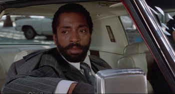 Movie still from “Prince of the City” (1981), directed by Sidney Lumet – A man sitting in the back seat of a car; Close Up shot, Low angle