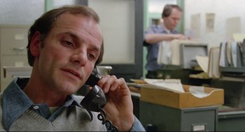Movie still from “Prince of the City” (1981), directed by Sidney Lumet – A man talking on a phone in an office setting; Close Up shot, Low angle