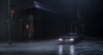 Movie still from “Prince of the City” (1981), directed by Sidney Lumet – A car driving down a street in the rain; Extreme Wide shot, High angle