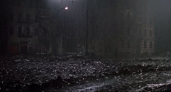 Movie still from “Prince of the City” (1981), directed by Sidney Lumet – A street light in the middle of a dark street; Extreme Wide shot, High angle