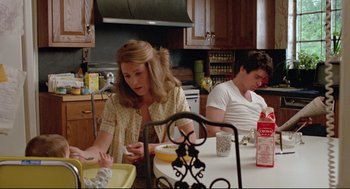 Movie still from “Prince of the City” (1981), directed by Sidney Lumet – Two people sitting at a table in a kitchen; Medium shot, Low angle