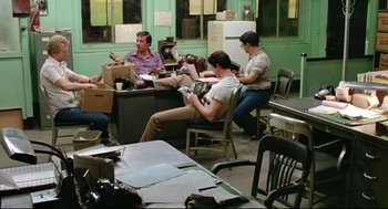Movie still from “Prince of the City” (1981), directed by Sidney Lumet – A group of people sitting around a table; Wide shot, High angle
