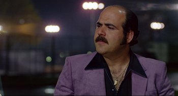 Movie still from “Prince of the City” (1981), directed by Sidney Lumet – A man in a purple jacket with a mustache; Close Up shot, Low angle