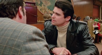 Movie still from “Prince of the City” (1981), directed by Sidney Lumet – A man in a leather jacket talking to another man in a brown jacket; Medium shot, Over the shoulder angle