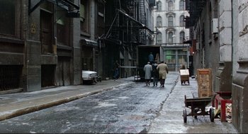 Movie still from “Prince of the City” (1981), directed by Sidney Lumet – A group of people walking down a street near a building; Extreme Wide shot, High angle