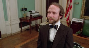 Movie still from “Prince of the City” (1981), directed by Sidney Lumet – A man in a suit and bow tie in a room; Close Up shot, High angle