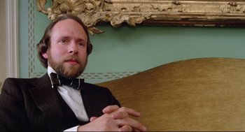 Movie still from “Prince of the City” (1981), directed by Sidney Lumet – A man in a tuxedo sitting in front of an ornate wall; Close Up shot, Low angle
