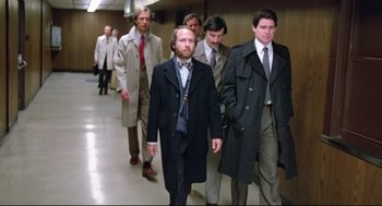 Movie still from “Prince of the City” (1981), directed by Sidney Lumet – A group of men walking down a hall way; Wide shot, Low angle