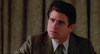 Movie still from “Prince of the City” (1981), directed by Sidney Lumet – A person wearing a suit and tie; Close Up shot, Low angle