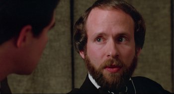 Movie still from “Prince of the City” (1981), directed by Sidney Lumet – A man with a beard is looking at a man with a beard; Close Up shot, Over the shoulder angle