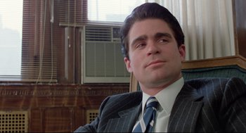 Movie still from “Prince of the City” (1981), directed by Sidney Lumet – A person wearing a suit and tie; Close Up shot, Low angle