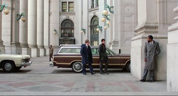 Movie still from “Prince of the City” (1981), directed by Sidney Lumet – Two men standing in front of a car on a sidewalk; Wide shot, Low angle