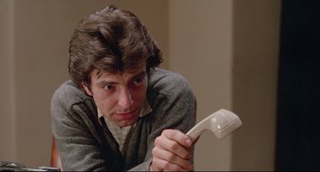 Movie still from “Prince of the City” (1981), directed by Sidney Lumet – A young man holding a phone up to his face; Close Up shot, Low angle