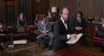 Movie still from “Prince of the City” (1981), directed by Sidney Lumet – A group of men in suits sitting in a conference room; Medium shot, Low angle