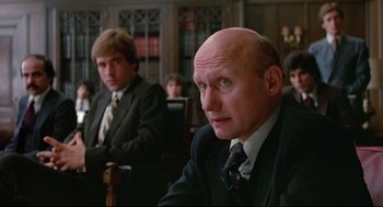Movie still from “Prince of the City” (1981), directed by Sidney Lumet – Two men in suits and ties sitting in a courtroom; Medium shot, Low angle
