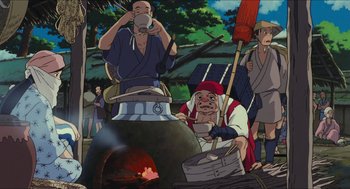 Movie still from “Princess Mononoke” (1997), directed by Hayao Miyazaki – An animated scene of people cooking food in an outdoor setting; Wide shot, Low angle