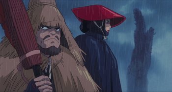 Movie still from “Princess Mononoke” (1997), directed by Hayao Miyazaki – An image of two people standing in the rain; Close Up shot, Low angle