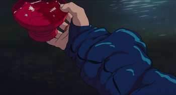 Movie still from “Princess Mononoke” (1997), directed by Hayao Miyazaki – A person holding a red object in their hand; Extreme Close Up shot, High angle