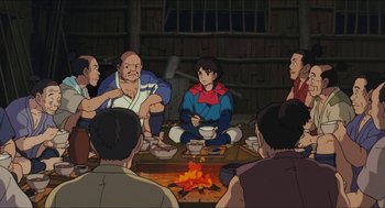Movie still from “Princess Mononoke” (1997), directed by Hayao Miyazaki – A group of people sitting around a fire pit; Medium shot, High angle