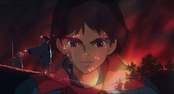 Movie still from “Princess Mononoke” (1997), directed by Hayao Miyazaki – A young man is looking into the distance in front of a fire background; Extreme Wide shot, High angle