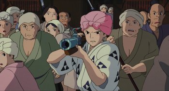 Movie still from “Princess Mononoke” (1997), directed by Hayao Miyazaki – A group of people are gathered around a woman with a camera; Medium shot, High angle