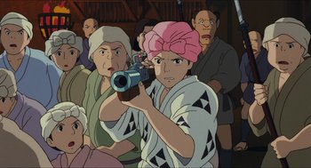 Movie still from “Princess Mononoke” (1997), directed by Hayao Miyazaki – An animated character is holding a gun in front of a group of people; Close Up shot, High angle