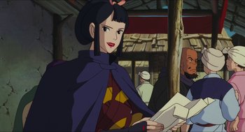 Movie still from “Princess Mononoke” (1997), directed by Hayao Miyazaki – A woman in a purple cape holding a piece of paper in her hands; Medium shot, Over the shoulder angle