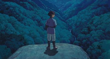 Movie still from “Princess Mononoke” (1997), directed by Hayao Miyazaki – A man standing on top of a hill looking at a valley; Wide shot, High angle