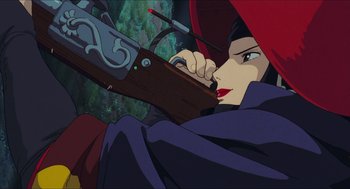 Movie still from “Princess Mononoke” (1997), directed by Hayao Miyazaki – A woman holding a rifle in a forest with trees in the background; Close Up shot, Low angle