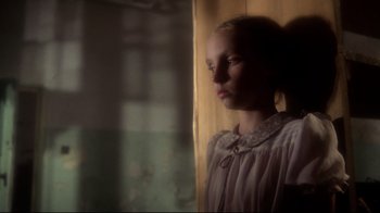 Movie still from “Prom Night” (1980), directed by Paul Lynch – A young girl is looking out of a window; Close Up shot, Low angle