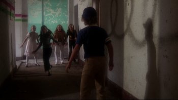Movie still from “Prom Night” (1980), directed by Paul Lynch – A group of people walking down a hall way; Wide shot, High angle