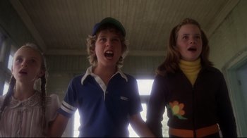Movie still from “Prom Night” (1980), directed by Paul Lynch – Two young people are singing together in a room; Medium shot, Low angle