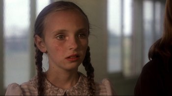 Movie still from “Prom Night” (1980), directed by Paul Lynch – A young girl with pigtails looking at the camera; Close Up shot, High angle