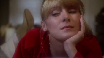 Movie still from “Prom Night” (1980), directed by Paul Lynch – A woman in a red shirt resting her head on her hand; Close Up shot, Low angle