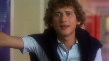Movie still from “Prom Night” (1980), directed by Paul Lynch – A young man with curly hair and a blue shirt; Close Up shot, Over the shoulder angle