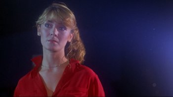 Movie still from “Prom Night” (1980), directed by Paul Lynch – A woman in a red shirt is looking at the camera; Close Up shot, Low angle
