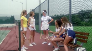 Movie still from “Prom Night” (1980), directed by Paul Lynch – A group of young women standing next to each other holding rackets; Wide shot, High angle