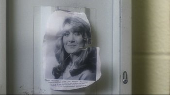 Movie still from “Prom Night” (1980), directed by Paul Lynch – A torn up picture of a woman on a door; Close Up shot, Low angle