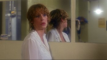 Movie still from “Prom Night” (1980), directed by Paul Lynch – A woman in a white shirt looking into a bathroom mirror; Close Up shot, Over the shoulder angle