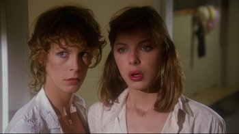Movie still from “Prom Night” (1980), directed by Paul Lynch – Two young women standing next to each other in a room; Close Up shot, Low angle
