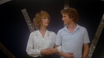 Movie still from “Prom Night” (1980), directed by Paul Lynch – A man and a woman standing next to each other; Medium shot, Low angle