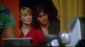 Movie still from “Prom Night” (1980), directed by Paul Lynch – A man and a woman looking out of a window; Close Up shot, Low angle