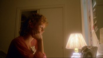 Movie still from “Prom Night” (1980), directed by Paul Lynch – A woman sitting in front of a lamp in a room; Close Up shot, Low angle