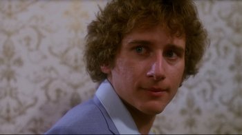 Movie still from “Prom Night” (1980), directed by Paul Lynch – A person with curly hair; Close Up shot, Low angle