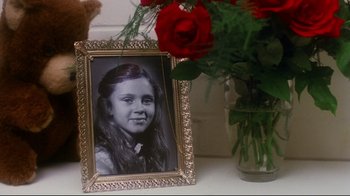 Movie still from “Prom Night” (1980), directed by Paul Lynch – A picture of a young girl in an ornate frame; Close Up shot, High angle