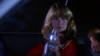 Movie still from “Prom Night” (1980), directed by Paul Lynch – A woman holding a cell phone in her hand; Close Up shot, Over the shoulder angle
