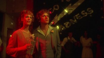 Movie still from “Prom Night” (1980), directed by Paul Lynch – A man and a woman standing next to each other; Medium shot, Low angle