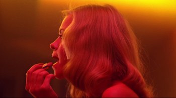 Movie still from “Prom Night” (1980), directed by Paul Lynch – A woman with long red hair is brushing her teeth; Close Up shot, Low angle