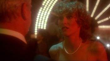 Movie still from “Prom Night” (1980), directed by Paul Lynch – A woman in a white dress is talking to a man in a suit; Close Up shot, Over the shoulder angle